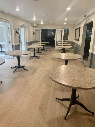 Commercial dining room with light color, wood-look flooring. 